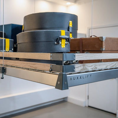 Auxx Lift motorized garage storage lift system neatly organizing luggage and boxes.