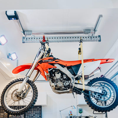 Auxx Lift motorized garage storage system effortlessly lifting a motorcycle for organized storage.